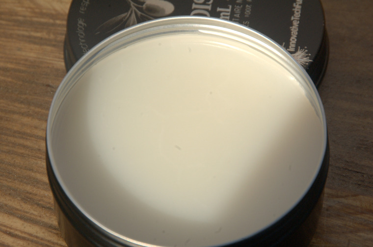 Thumbnail of Gros plan dans le pot de cire pour bois : texture crémeuse beige clair dans un pot en aluminium noir